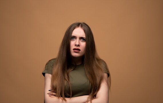 Young woman feeling confused and surprised, showing skepticism and disbelief with a shocked facial expression