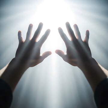 Silhouette of hands raised in prayer or meditation.