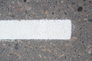 Fototapeta premium Fresh white dotted lane markings line the city's asphalt street. A close-up of the new road markings in the city