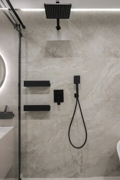 Black rain shower head in the bathroom