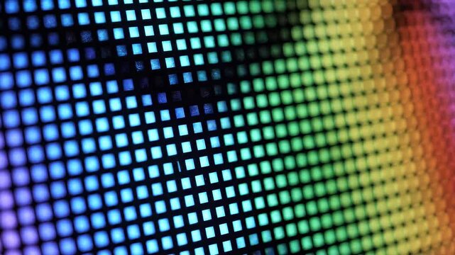 Close-up of vibrant LED screen displaying colorful pixelated patterns with a futuristic, digital atmosphere.
