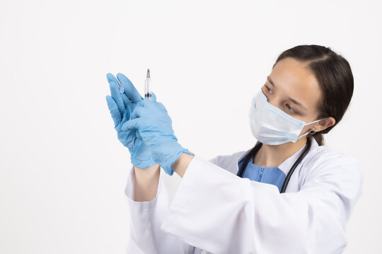Female doctor holding a medical syringe needle for stock photography web use