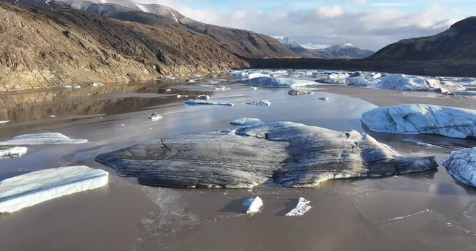 Drone cinematic flight over a massive frozen glacier ice cap in Iceland wilderness