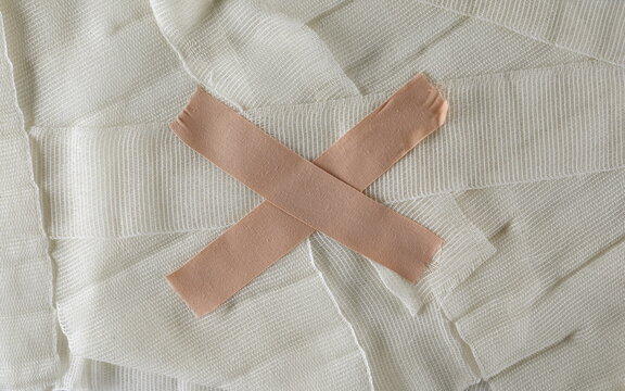 Adhesive bandage on medical bandage background and texture, top view