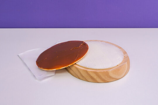 A crispy oblea wafer filled with fresh white cheese and topped with caramel sprea