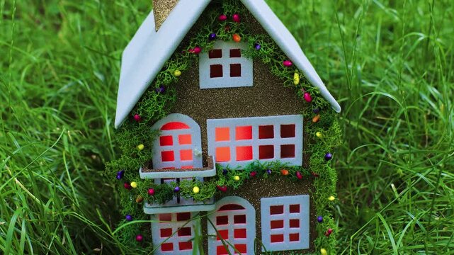 Among the dense greenery there is a beautiful fairytale decorated house with a white roof