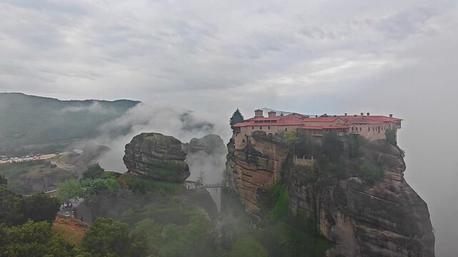 Aerial view of Meteora monasteries and the rock formations in the mountains of Greece near Kalabaka city. Monastery of the Holy Trinity. Unesco world heritage site. Drone Video