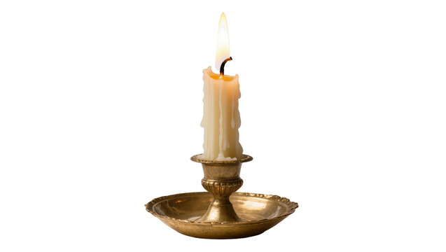 Isolated vintage brass candlestick with a burning candle casting warm light and glow