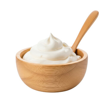Wooden bowl with whipped cream and wooden spoon