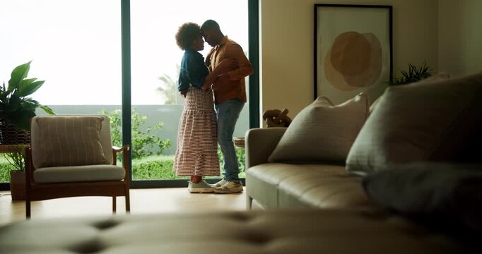 Couple, dance and holding hands in lounge, love and bonding with partner on anniversary and spinning. Black people, home and forehead touch with spouse, rhythm and happy for relationship milestone