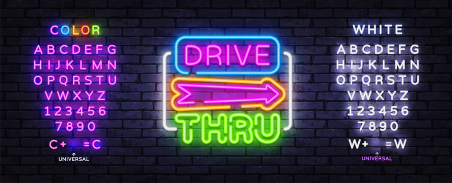 Editable Drive Thru neon sign with colorful alphabet and arrow on brick wall. Retro fast food template for takeaway cafe, diner branding and roadside advertising.