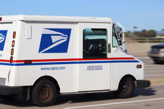 USPS Mail Truck in Motion on a Daily Delivery Route