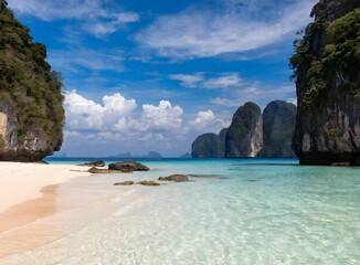 Obraz premium Tropical beach with white sand and turquoise water near limestone cliffs