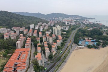 Obraz premium Beachfront Residential District with Elevated Highway and Sandy Shore