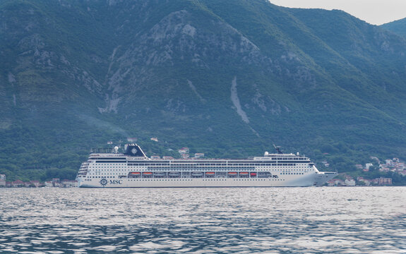 Large MSC cruise ship sailing in the Bay of Kotor against scenic mountains: 11.06.2026 - Dobrota, Kotor, Montenegro
