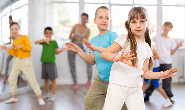 Young children couple learns to hali gali pair dance during class in studio, repeat movements and learn energy social couple dance. Studio school for amateur and professional dancers
