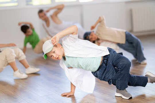 Group of active children dancers having break dance training at dance studio