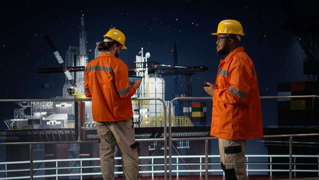 Doing radio coordination, embargo and engineering team on drilling barge, Mitigating oil crisis disruptions, northern lights and african american man with coworker on offshore platform, camera A.