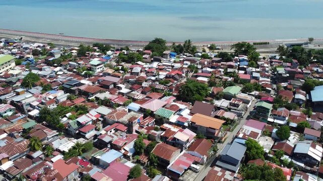 Drone aerial footage of Davao, Philippines featuring dense urban housing, residential neighborhoods, city infrastructure, bridge and compact urban development captured from above.