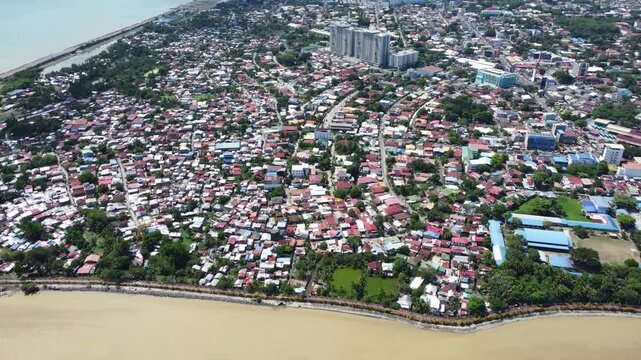 Drone aerial footage of Davao, Philippines featuring dense urban housing, residential neighborhoods, city infrastructure, bridge and compact urban development captured from above.