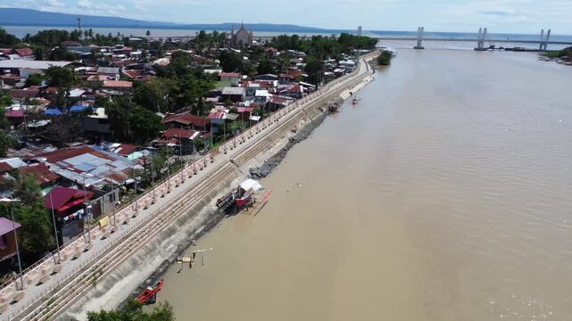 Drone aerial footage of Davao, Philippines featuring dense urban housing, residential neighborhoods, city infrastructure, bridge and compact urban development captured from above.