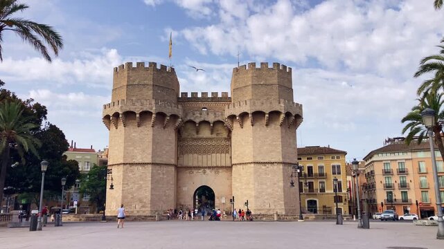 Historic Torres de Serranos rises above lively commercial streets showcasing remarkable Spanish architecture and rich cultural heritage in Valencia, Spain