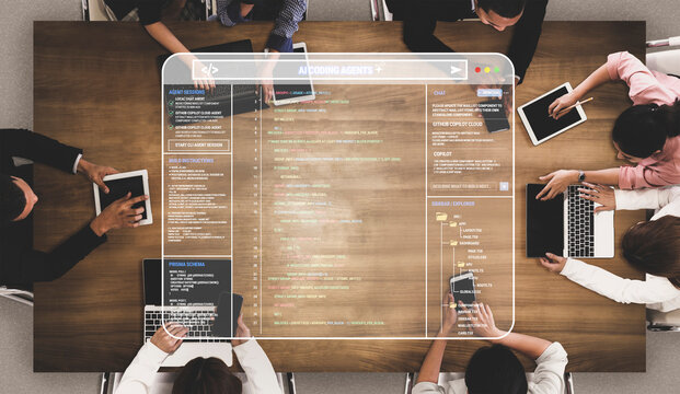 Collaborative Technology Meeting with Laptops and Tablets on a Wooden Table Displaying Code and Digital Data Visualization Quark.