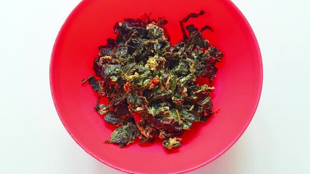 Traditional chaya Cnidoscolus aconitifolius leaves with scrambled eggs in red bowl Peten Guatemala