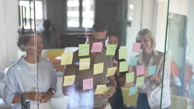 Diverse business team brainstorming ideas using sticky notes
