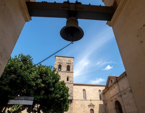 Bell Tower Against Historic Building Under Blue Sky.