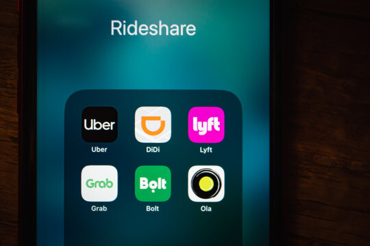 Mexico City, MEXICO - Jun 16 2026 : Close-up of a smartphone displaying a Rideshare app folder with icons for Uber, DiDi, Lyft, Grab, Bolt, and Ola.