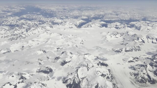 Glacier tongues spill between rocky nunataks across a white icefield