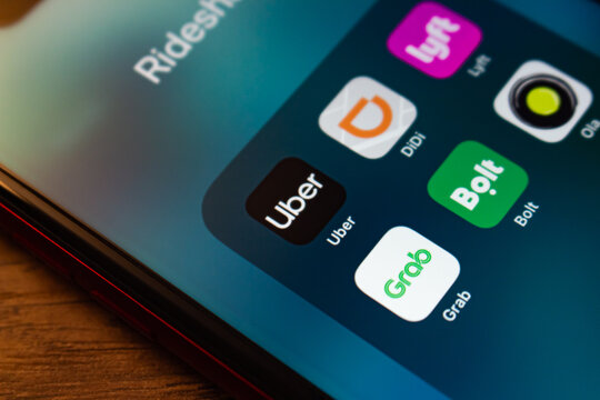 Mexico City, MEXICO - Jun 16 2026 : Close-up of a Rideshare app folder with Uber, Lyft, Didi, Bolt, Grab, and Ola on a blue gradient home screen.