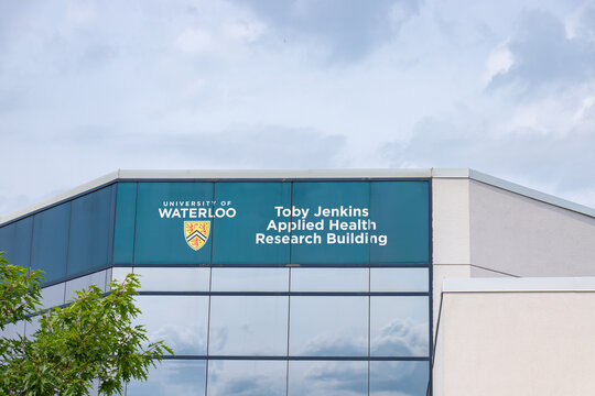Waterloo, ON, CANADA - Aug 5 2024 : Exterior signage of the Toby Jenkins Applied Health Research Building at the University of Waterloo, featuring the institution's shield logo.