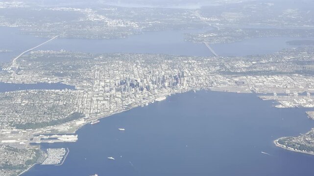 Aerial flyby of Seattle's skyline above a busy Elliott Bay
