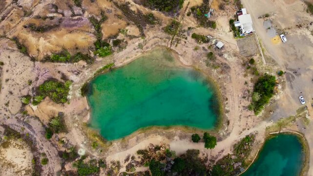 Hotizontal_Aerial drone view of the blue lakes surrounded by trees and arid deserts in Villa De Leyva, Boyaca ,Colombia 4k