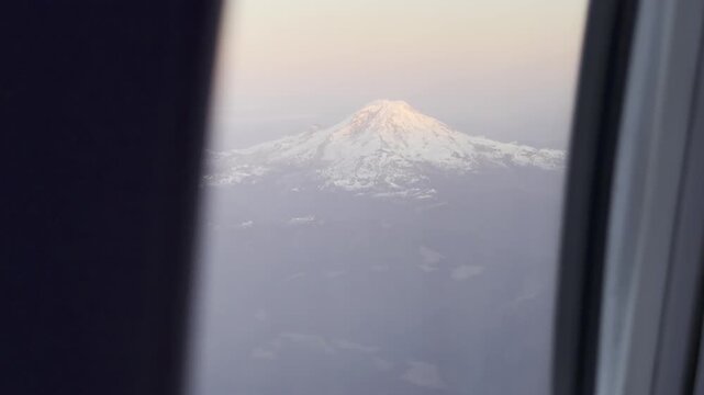 Crisp snowfields wrap the icy flanks of Mount Rainier at last light
