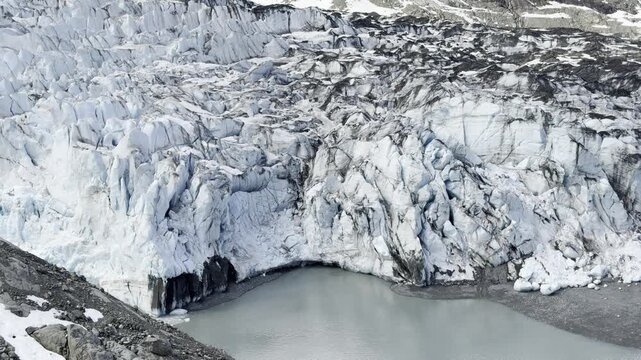 Crevassed ice towers crowd Lamplugh Glacier above a meltwater pool