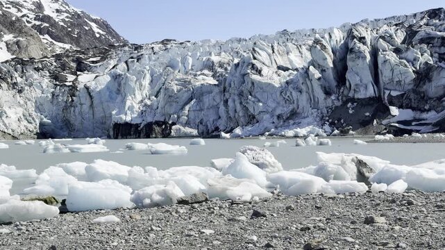 Brash ice packs a gray lagoon below Lamplugh Glacier's terminus