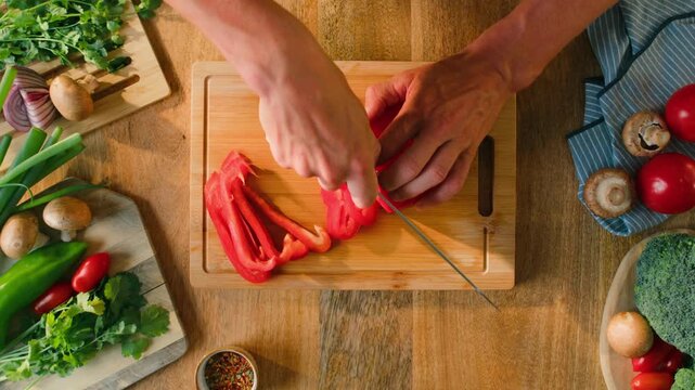 Man cut red sweet pepper, Chef hands with knife for onion, cutting and preparation with cooking for dish. Restaurant, culinary service and cook with skills for catering, business and hospitality by