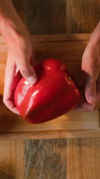 Man cut yellow sweet pepper, Chef hands with knife for onion, cutting and preparation with cooking for dish. Restaurant, culinary service and cook with skills for catering, business and hospitality by