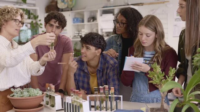 Teacher showing science experiment to class at high school
