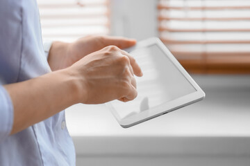 Person using a tablet device indoors © Pixel-Shot