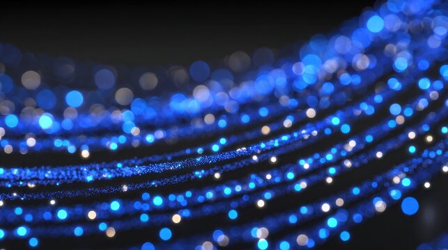 Numerous glowing blue and white light streams flow across a dark background creating abstract waves of illumination.