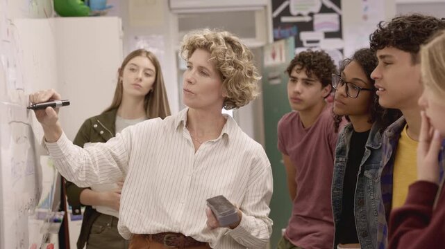 High school teacher giving lesson to multiethnic students