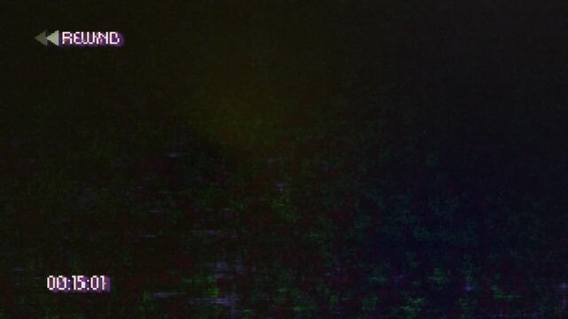 Retro VHS tape with rewind symbol with decreasing timecode and static effect.
