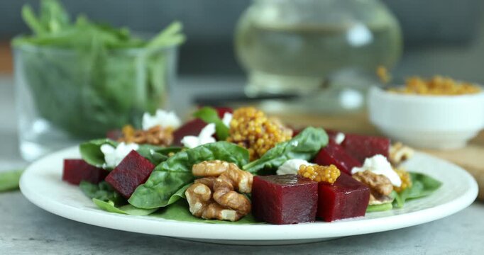 Eating tasty salad with boiled beets at grey table, closeup