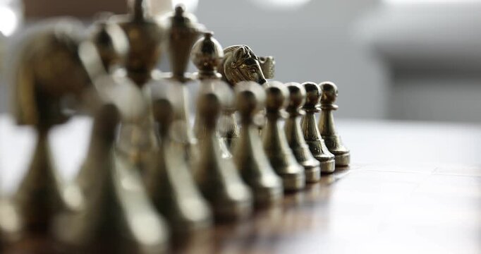 Chess pieces on game board, closeup. Camera refocusing