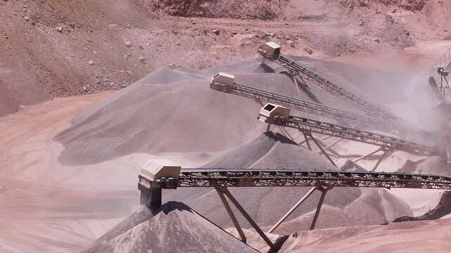 Industrial Conveyors Depositing Crushed Stone Into Large Quarry Stockpiles