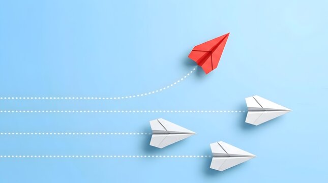 Red paper airplane flying ahead of a group of white paper airplanes on a blue background, representing leadership and individuality.